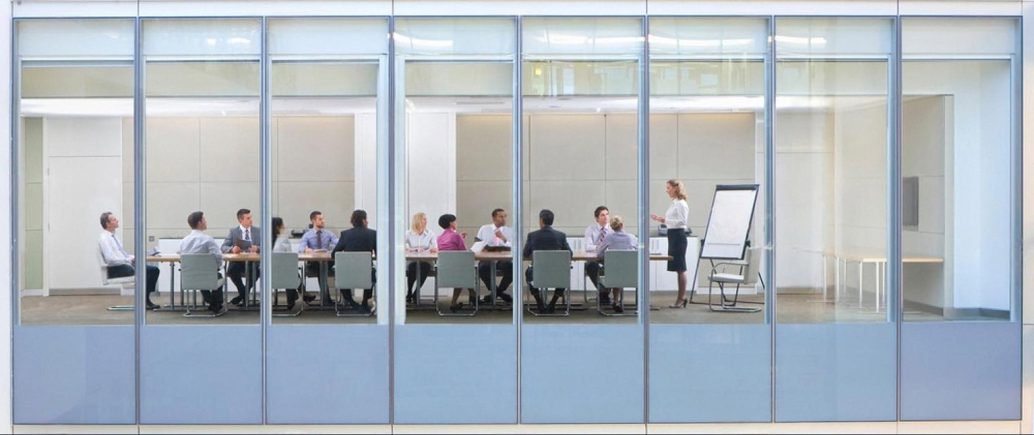 UAE corporate team in a glass-walled boardroom during a staff engagement session