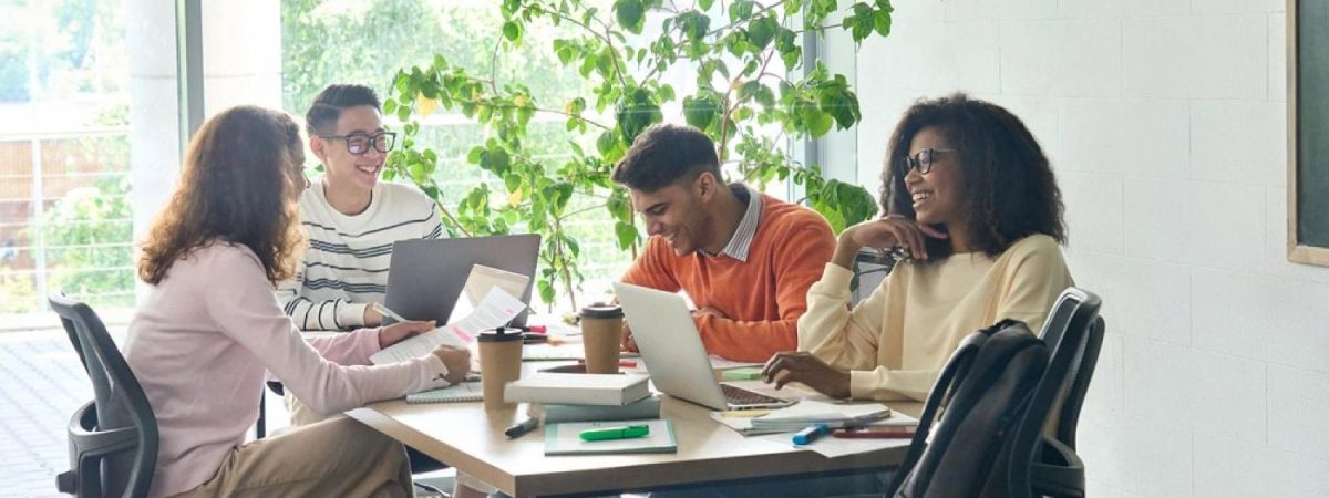 Diverse young professionals collaborating around a table in a Dubai office